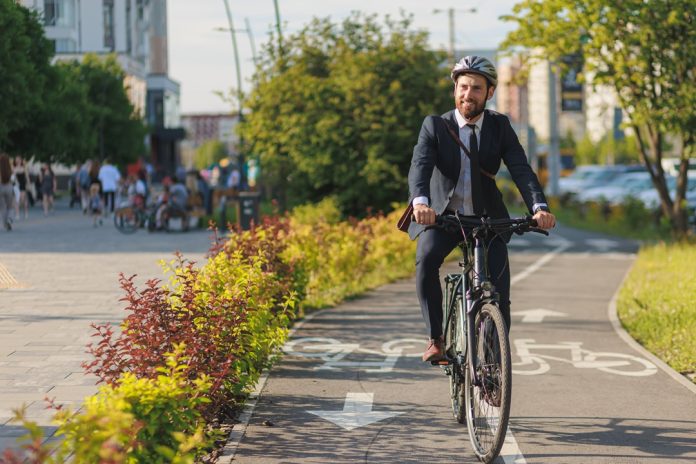 Successful,Male,Executive,In,Elegant,Suit,Smiling,,While,Riding,On
